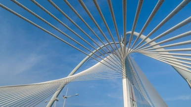 Low angle view of suspension bridge against sky
