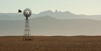 Windmill in field